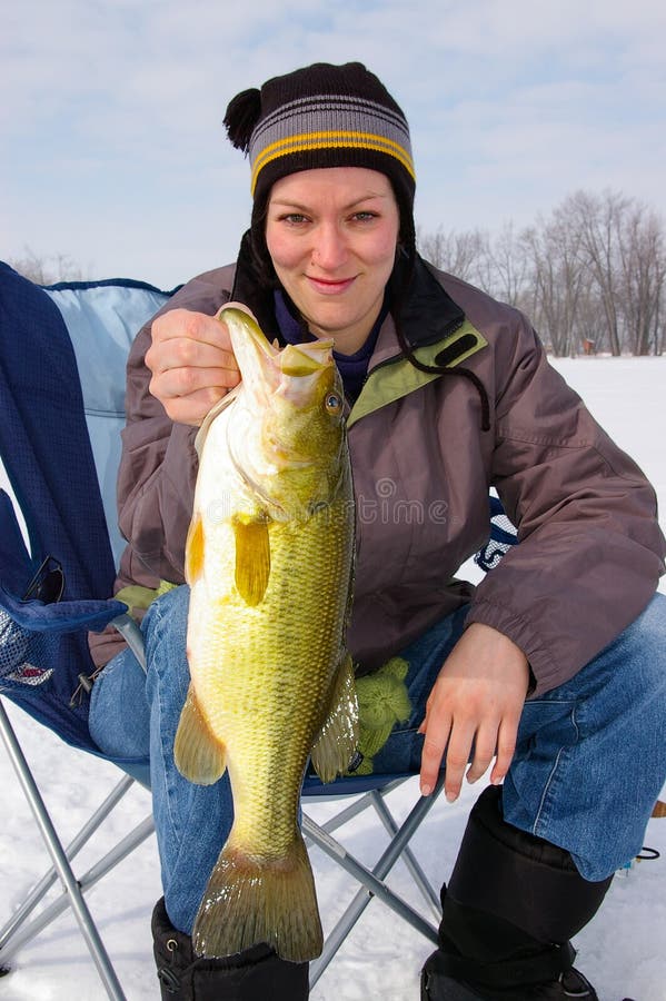 Дама Рыболов Fisherwoman Держать рыбная ловля льда Largemouth баса уловленная стоковая фотография rf Дама Рыболов Fisherwoman Держать рыбная ловля льда Largemouth баса уловленная стоковая фотография rf