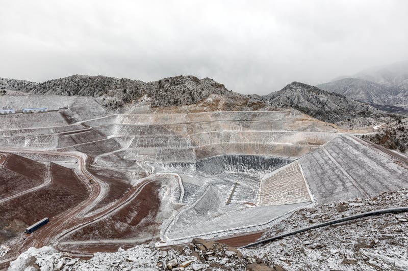 New industrial mine waste dam (tailing dam) with snowy weather. Tailings dams rank among the largest engineered structures on earth. Open pit mine. New industrial mine waste dam (tailing dam) with snowy weather. Tailings dams rank among the largest engineered structures on earth. Open pit mine.