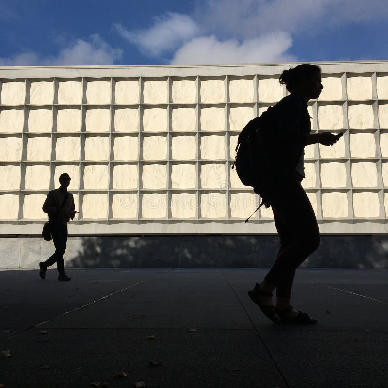 A male and female student rush off to class on the campus of Yale University. A male and female student rush off to class on the campus of Yale University