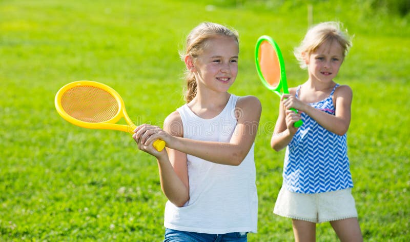 Two happy little girls playing active games in summer park. Two happy little girls playing active games in summer park