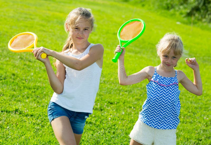 Two happy little girls playing active games in summer park. Two happy little girls playing active games in summer park