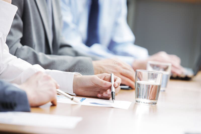 Close up of hands of business people during a meeting. Close up of hands of business people during a meeting