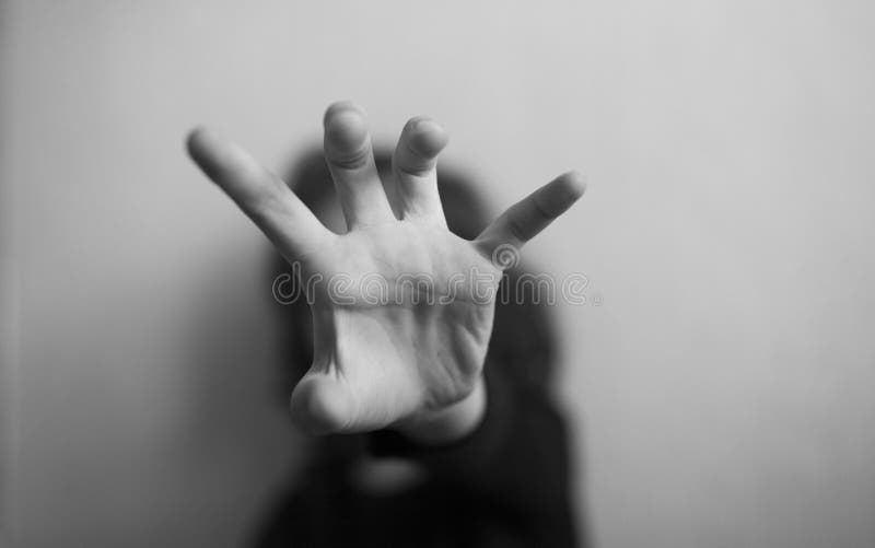 Little girl protects herself with hands from attack on a light background. Little girl protects herself with hands from attack on a light background