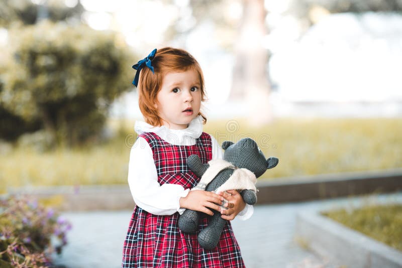 Cute baby girl 1-2 year old holding teddy bear outdoors. Looking at camera. Childhood. Cute baby girl 1-2 year old holding teddy bear outdoors. Looking at camera. Childhood