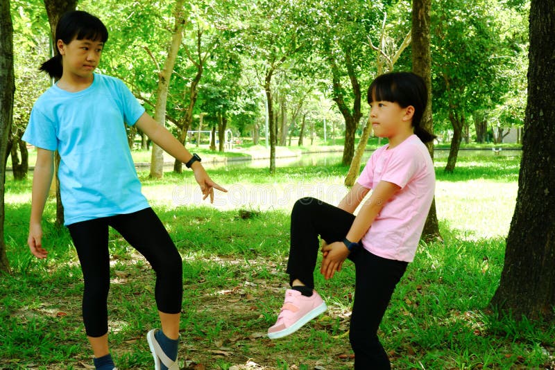 2 girls exercising in the park. 2 girls exercising in the park