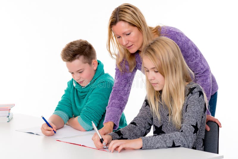 Girl and boy learning together with teacher in the classroom. Girl and boy learning together with teacher in the classroom