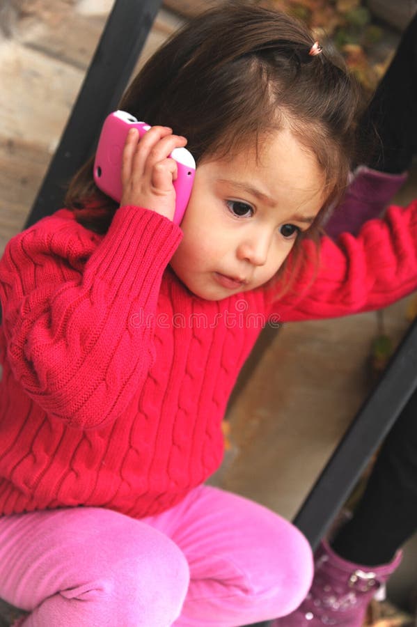 2 year old girl talking over the phone. 2 year old girl talking over the phone