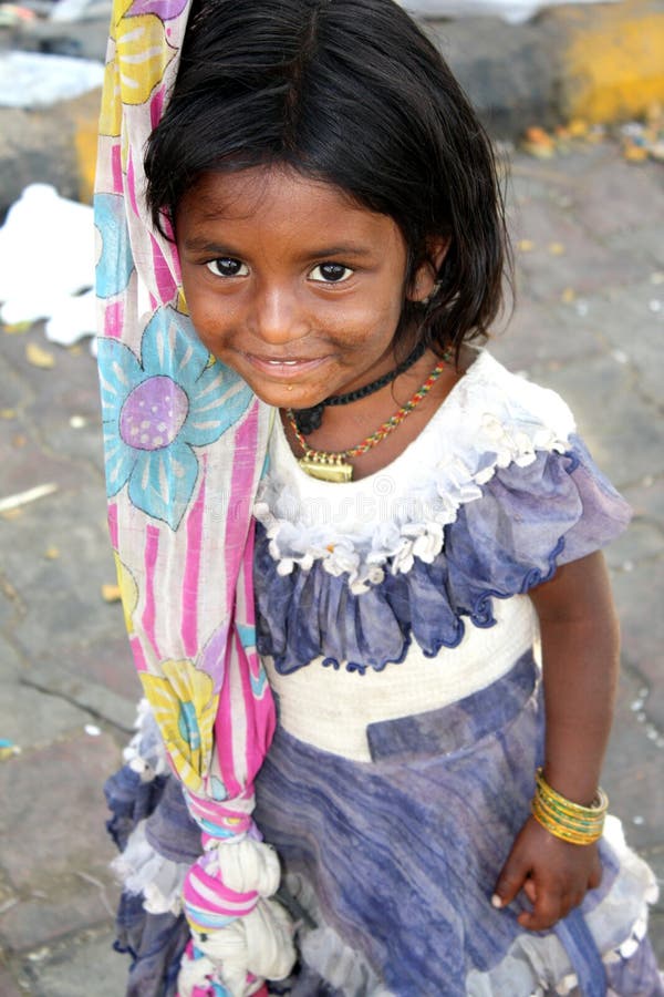 A shy Indian beggar girl looking at the camera. A shy Indian beggar girl looking at the camera.