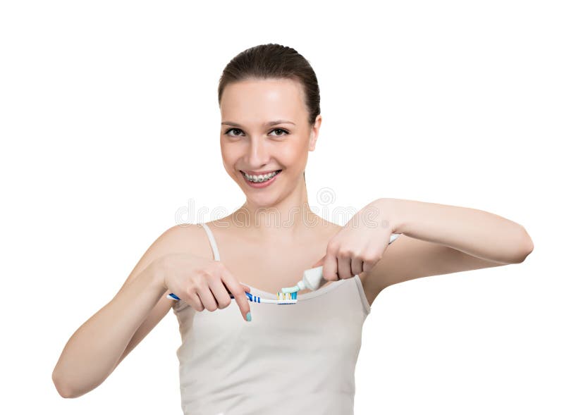 Girl with braces, tooth paste and brush isolated on white. Girl with braces, tooth paste and brush isolated on white