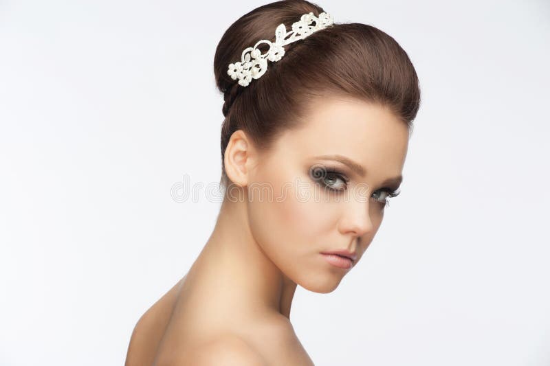 Portrait of a pretty young woman with a beautiful bridal hairstyle and makeup. Portrait of a pretty young woman with a beautiful bridal hairstyle and makeup