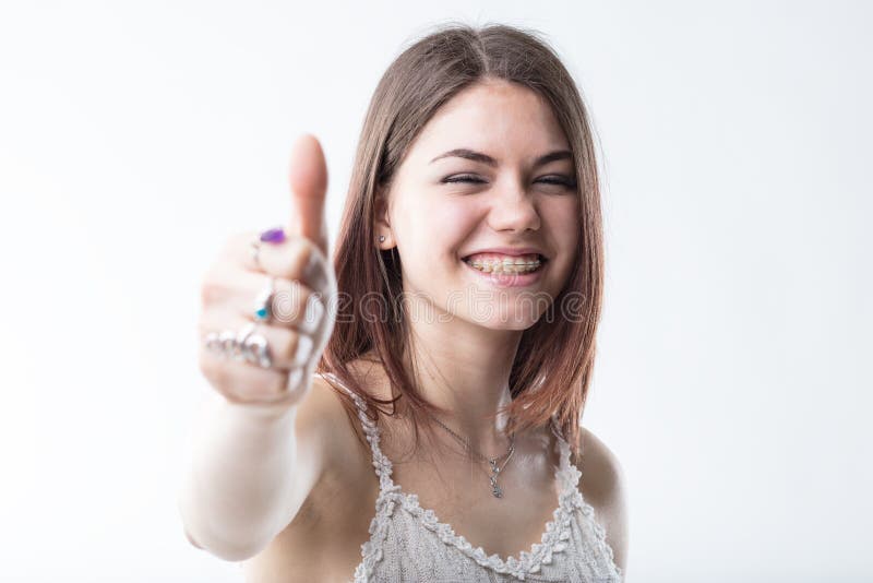 Thumbs up for dental healthcare, says this lovely girl with braces. Thumbs up for dental healthcare, says this lovely girl with braces