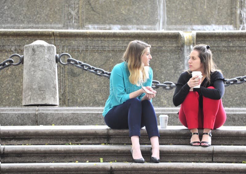 2 young ladies have a serious conversation on the steps of an office building in New York on 5/17/17. 2 young ladies have a serious conversation on the steps of an office building in New York on 5/17/17