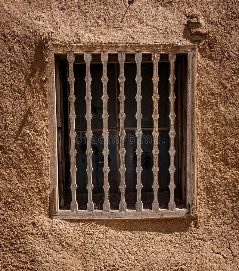 Decorative wooden grating protects window in Santa Fe, New Mexico. Decorative wooden grating protects window in Santa Fe, New Mexico