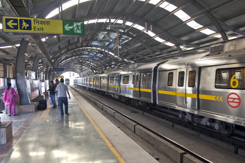 DELHI - NOVEMBER 11: passengers in metro station with arriving train on November 11, 2011 in Delhi, India. Nearly 1 million passengers use the metro daily. DELHI - NOVEMBER 11: passengers in metro station with arriving train on November 11, 2011 in Delhi, India. Nearly 1 million passengers use the metro daily.