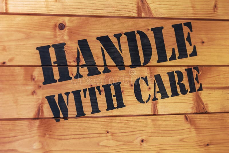 Wooden box with text handle with care. handle with care concept. Wooden box with text handle with care. handle with care concept.