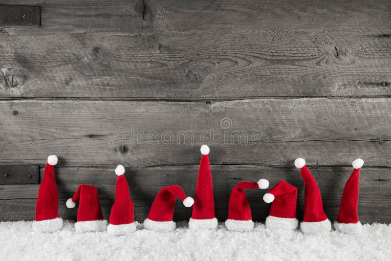 Деревянная предпосылка рождества с красными шляпами santa для праздничного fr стоковые изображения
