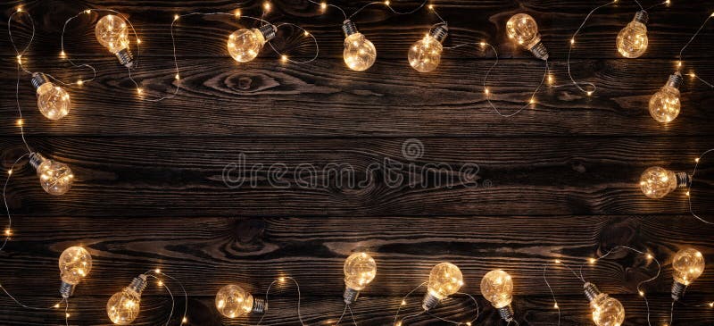 Empty, dark wooden background illuminated by retro light bulbs, with copy space. Empty, dark wooden background illuminated by retro light bulbs, with copy space