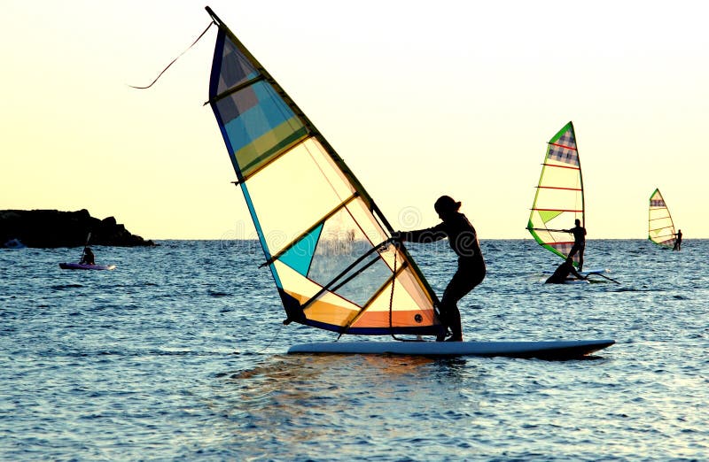 3 windsurfers in a row. 3 windsurfers in a row