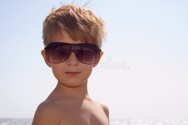 Young happy trendy with sun glasses over summer blue sky. Young happy trendy with sun glasses over summer blue sky