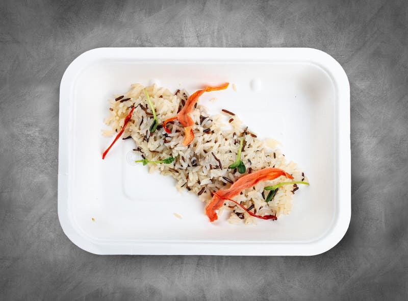 Steamed wild rice. Healthy food. Takeaway food. Top view, on a gray background. Steamed wild rice. Healthy food. Takeaway food. Top view, on a gray background.