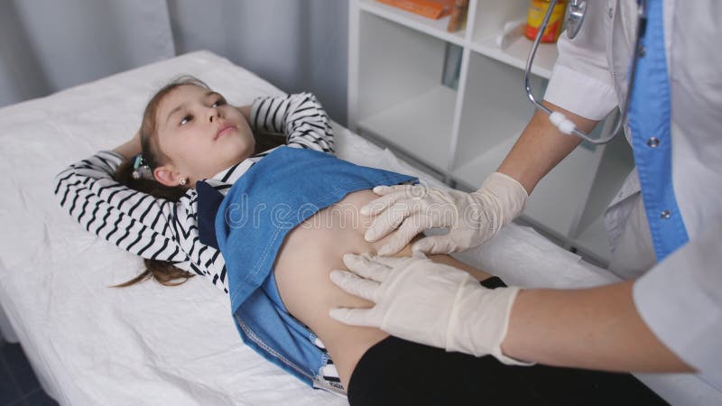 Female Doctor Feeling Little Girl Patient