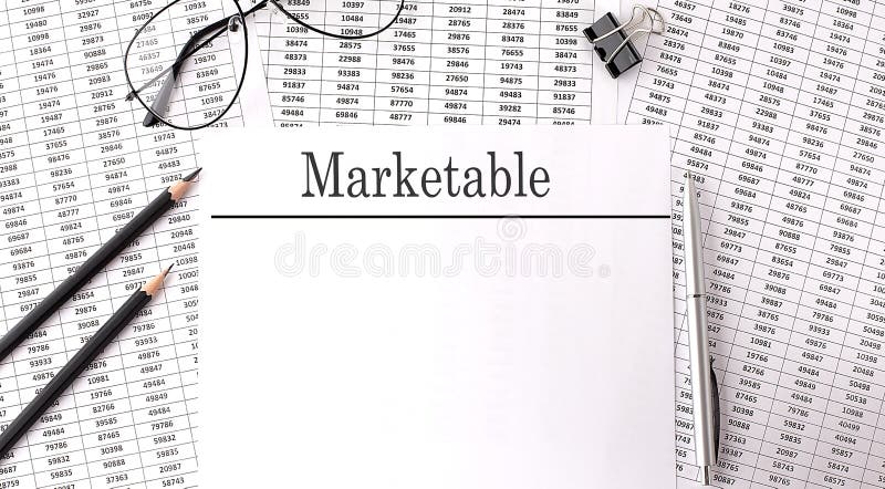 Paper with MARKETABLE action plans on a table, business. Paper with MARKETABLE action plans on a table, business