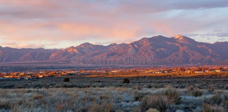 Taos Valley, New Mexico at sunset viewed from Llano, with Sangre de Cristo Mountains in the background. Taos Valley, New Mexico at sunset viewed from Llano, with Sangre de Cristo Mountains in the background