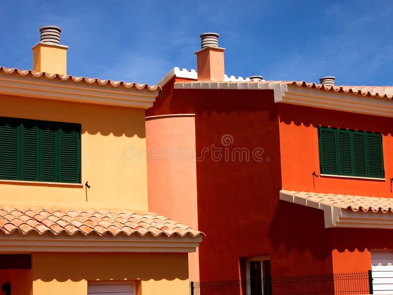 Brightly colored beach homes on the island of mallorca spain look brilliant against the blue sky. Brightly colored beach homes on the island of mallorca spain look brilliant against the blue sky