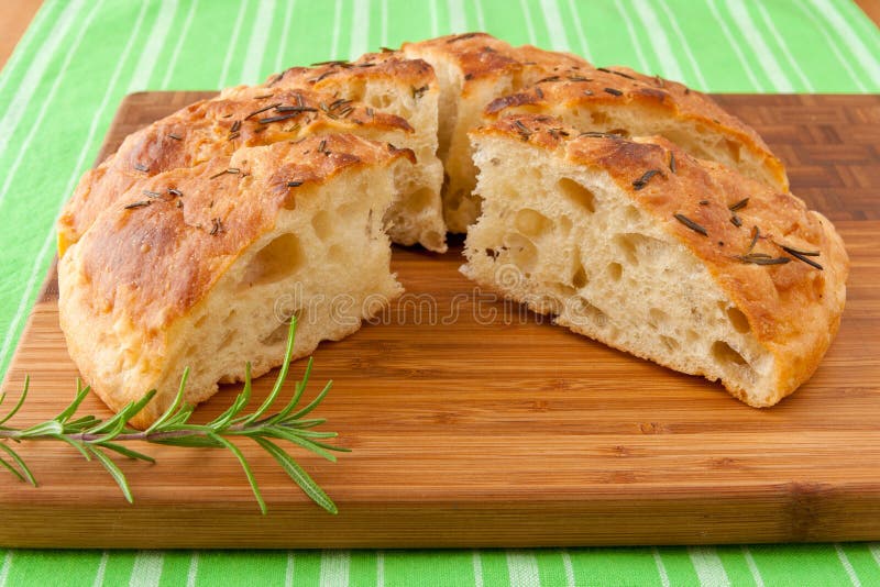 Homemade round Italian rosemary Focaccia bread sliced. Homemade round Italian rosemary Focaccia bread sliced.