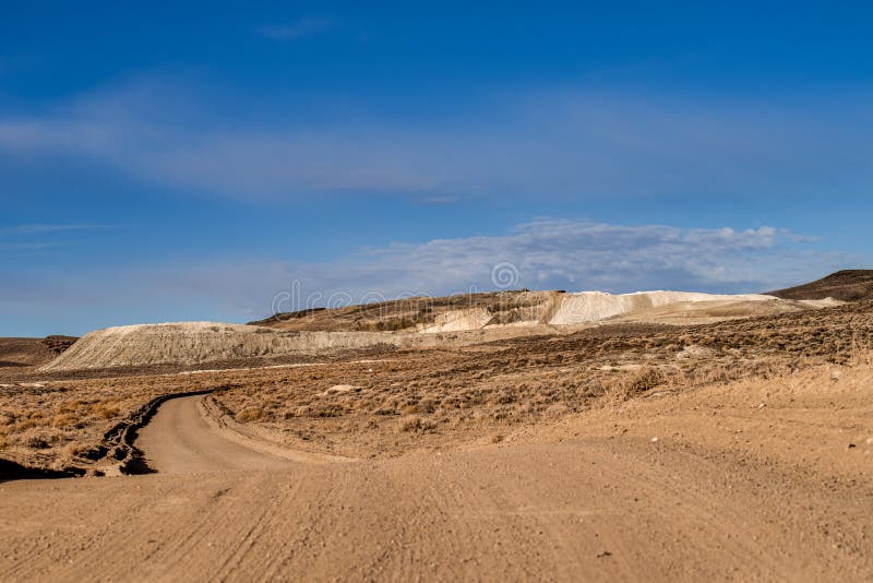 Road leading to Large mining tailings in the Northern Nevada desert with copy space. Road leading to Large mining tailings in the Northern Nevada desert with copy space