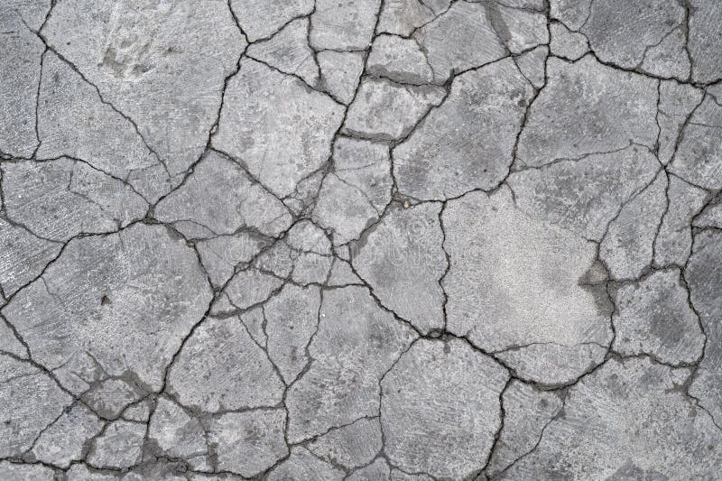 Terrain road with small rocks and cracks on the concrete wall. Terrain road with small rocks and cracks on the concrete wall