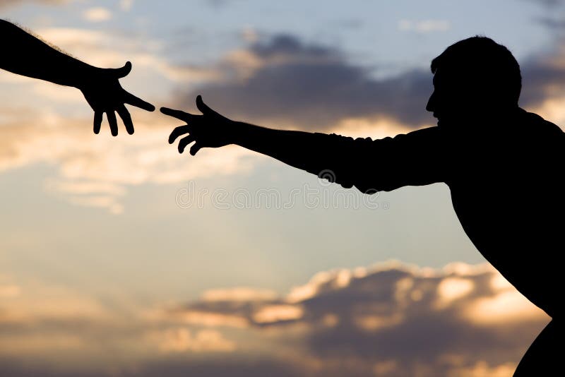 A young man reaching for help from another hand. A young man reaching for help from another hand