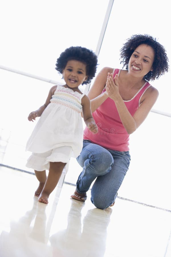 Mother and daughter indoors playing and smiling. Mother and daughter indoors playing and smiling