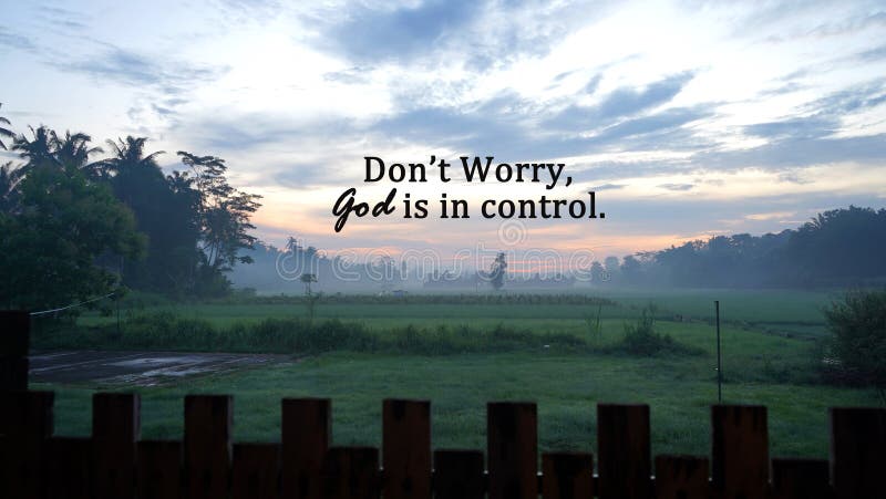 Spiritual inspirational quote - Don't worry, God is in control. On beautiful background of the sunrise over the green field. Faith and hope concept. Believe in God. Spiritual inspirational quote - Don't worry, God is in control. On beautiful background of the sunrise over the green field. Faith and hope concept. Believe in God