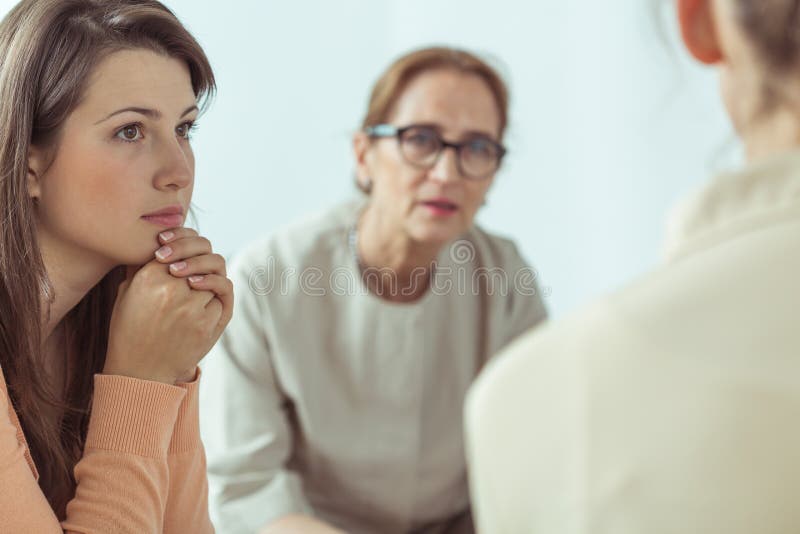 Mature spiritual guide talking with young women. Mature spiritual guide talking with young women