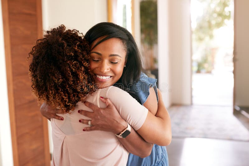 Loving Senior Mother Hugging Adult Daughter Indoors At Home. Loving Senior Mother Hugging Adult Daughter Indoors At Home