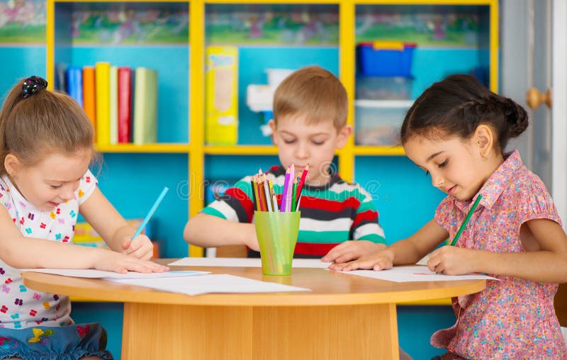 3 дети дошкольного возраста рисуя на daycare стоковое изображение