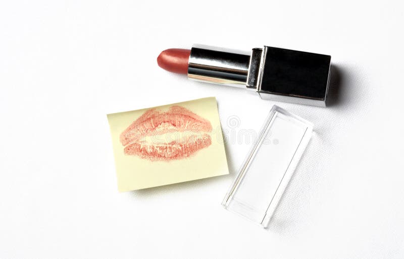 Red lipstick and yellow sticker note with kiss over white. Red lipstick and yellow sticker note with kiss over white