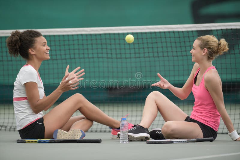 Two female tennis players sitting together on court 2. Two female tennis players sitting together on court 2