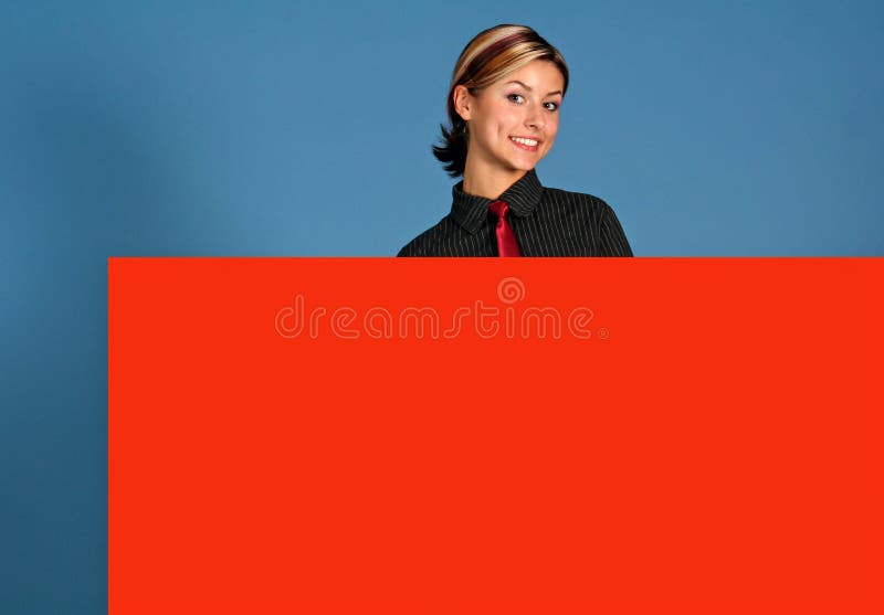 A attractive young woman holding a big red sign. A attractive young woman holding a big red sign.