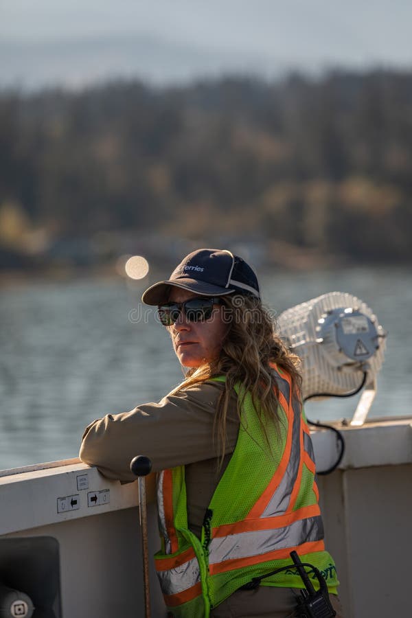 Female security officer in a safety vest standing at the BC Ferries ship. Professional Woman Working on the ship. Travel photo, editorial-October 2,2022-Vancouver Island Canada. Female security officer in a safety vest standing at the BC Ferries ship. Professional Woman Working on the ship. Travel photo, editorial-October 2,2022-Vancouver Island Canada