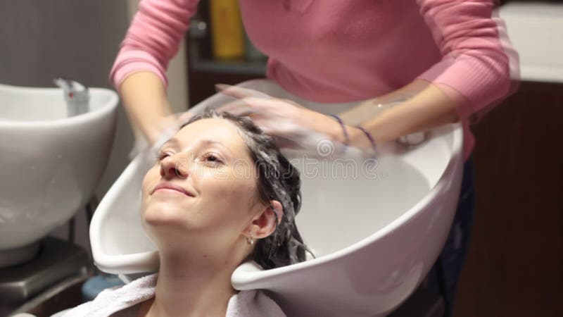 Женщина получая мытье волос