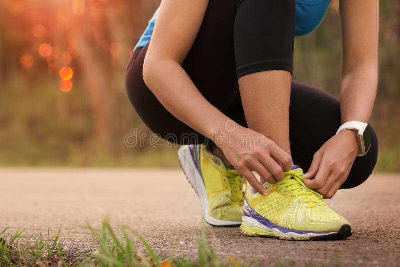 Woman tying sport shoes ready for run. Woman tying sport shoes ready for run