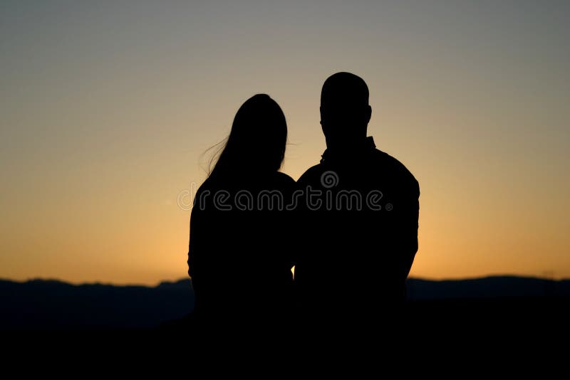 Wonderful silhouette of a male and female couple at sunset. Wonderful silhouette of a male and female couple at sunset.