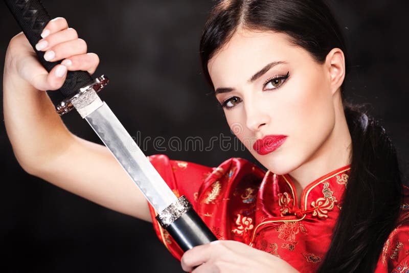 Pretty woman holding katana weapon. Pretty woman holding katana weapon