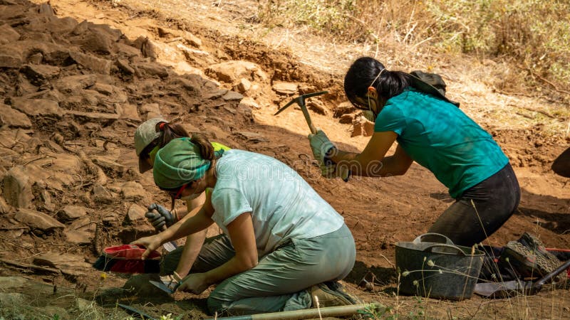 MELLANES, SPAIN - AUGUST 24: Two archaeologist women work in Mellanees village old fort on August 24, 2018 in Spain. MELLANES, SPAIN - AUGUST 24: Two archaeologist women work in Mellanees village old fort on August 24, 2018 in Spain