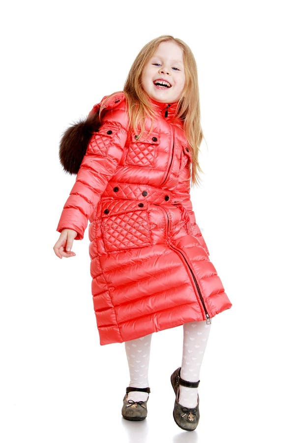 Cheerful little girl in a red quilted coat- isolated on white background. Cheerful little girl in a red quilted coat- isolated on white background