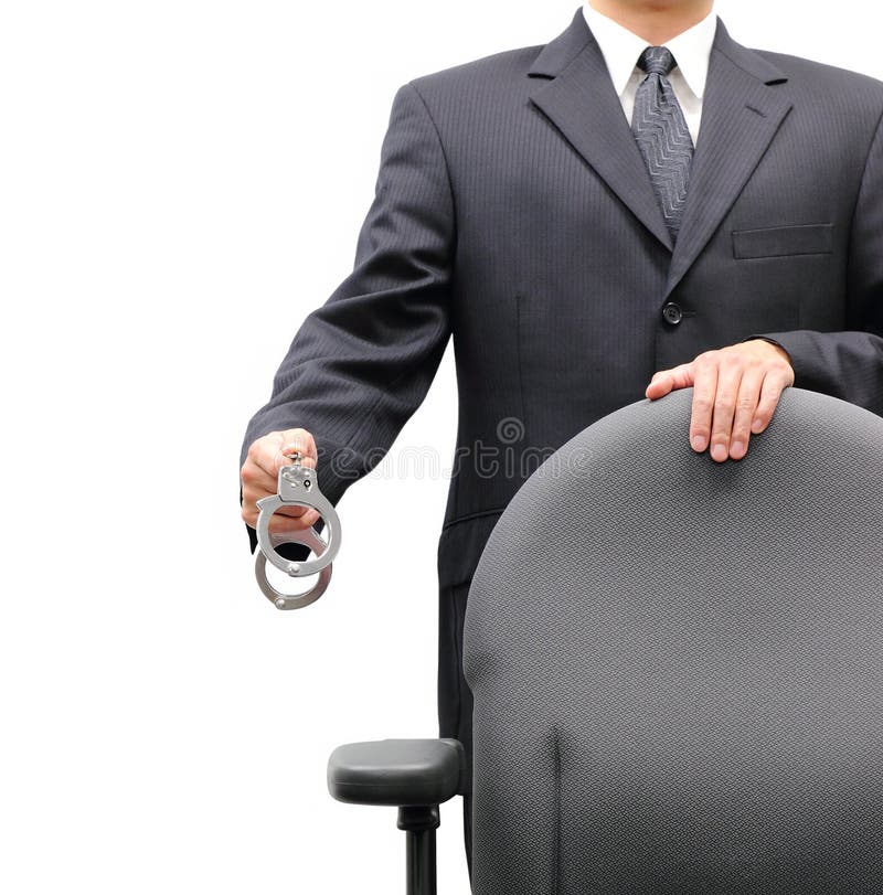 Business man standing behind an office chair holding a pair of handcuffs, isolated on a white background. Business man standing behind an office chair holding a pair of handcuffs, isolated on a white background.