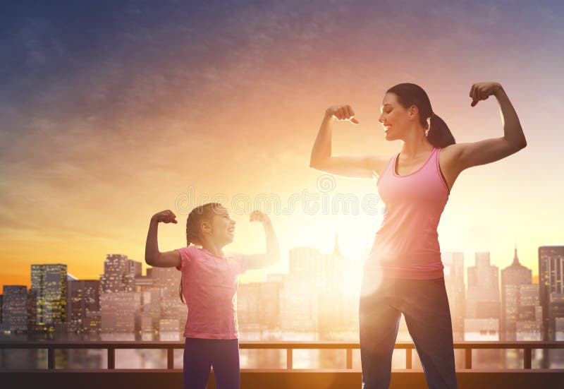 Athletic young women and her daughter are running on background of urban landscape. Healthy lifestyle. Family sport. Athletic young women and her daughter are running on background of urban landscape. Healthy lifestyle. Family sport.