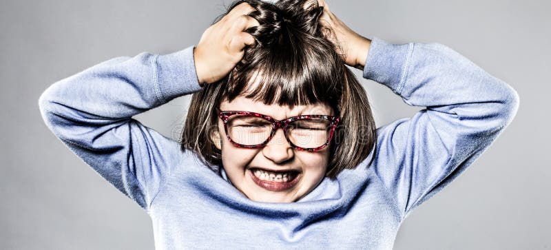 Furious small kid having a tantrum, pulling out her hair for itchy allergies or scratching her head for anger and frustration, contrast effects. Furious small kid having a tantrum, pulling out her hair for itchy allergies or scratching her head for anger and frustration, contrast effects